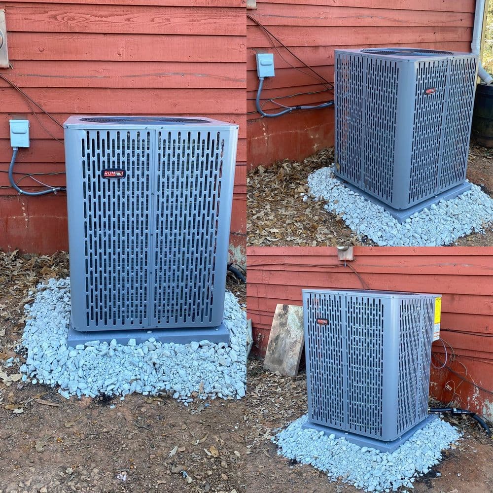 New HVAC unit installation outside a house, positioned on gravel near a red wood wall.